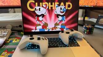 razer blade 18 gaming laptop playing cuphead with two xbox controllers on top of the keyboard