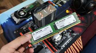 A person holding an ECC memory module, with a server PC, headphones, and a GTX 1080 in the background