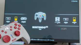 A console controller with a TV displaying the EmulationStation home screen in the background