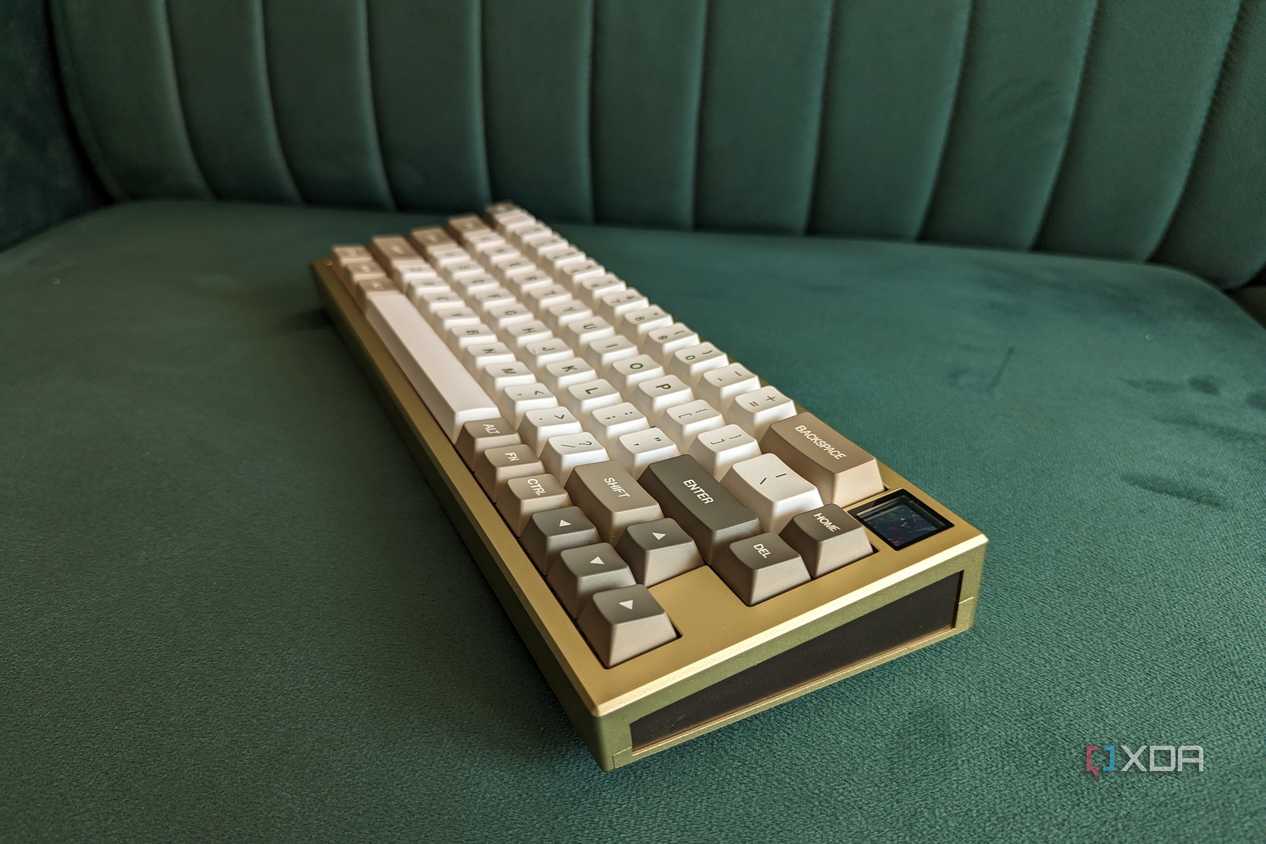 A gold and white mechanical keyboard on a green surface