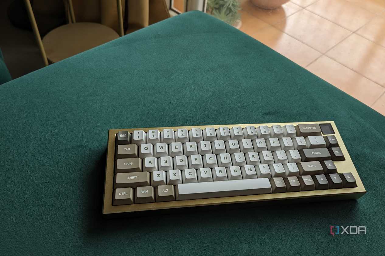 A gold and white keyboard on a green surface