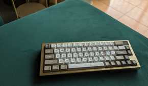 A gold and white keyboard on a green surface