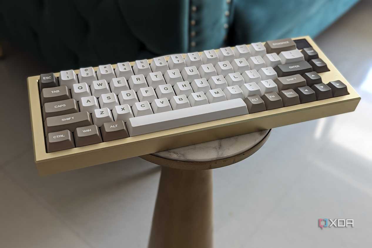 A gold and white keyboard placed on a stand