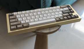 A gold and white keyboard placed on a stand