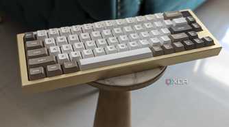 A gold and white keyboard placed on a stand