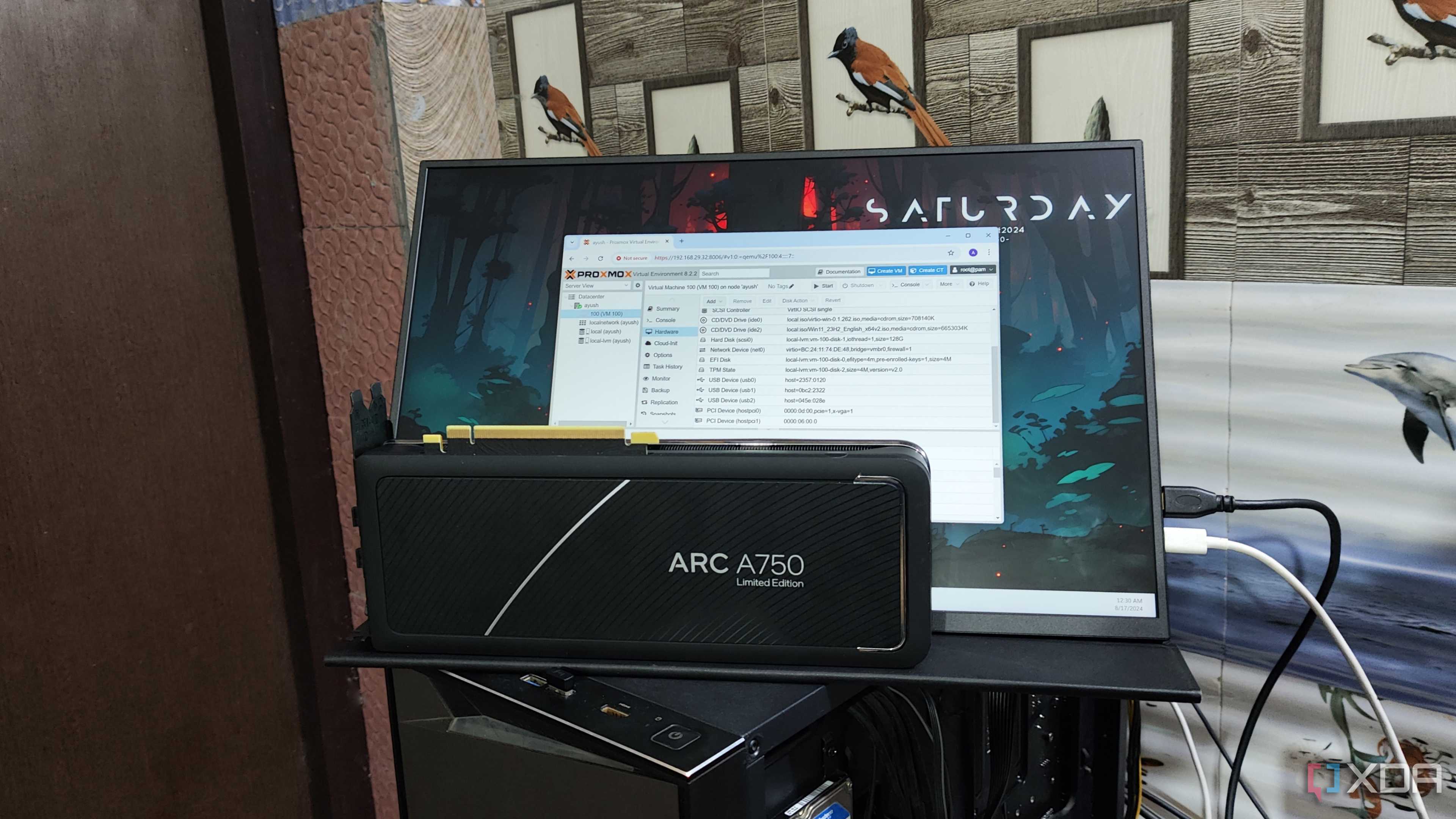 An Intel Arc A750 GPU placed in front of a UGame K118 monitor displaying the Proxmox web UI