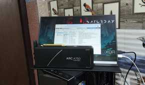 An Intel Arc A750 GPU placed in front of a UGame K118 monitor displaying the Proxmox web UI
