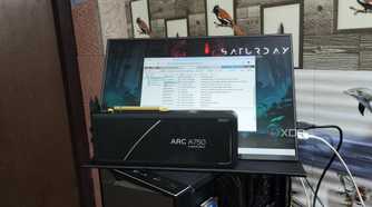 An Intel Arc A750 GPU placed in front of a UGame K118 monitor displaying the Proxmox web UI