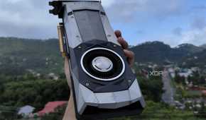 A person holding a GTX 1080 Founders Edition GPU