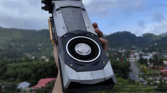 A person holding a GTX 1080 Founders Edition GPU