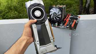 A person holding a GTX 1080 Founders Edition GPU in front of a server PC
