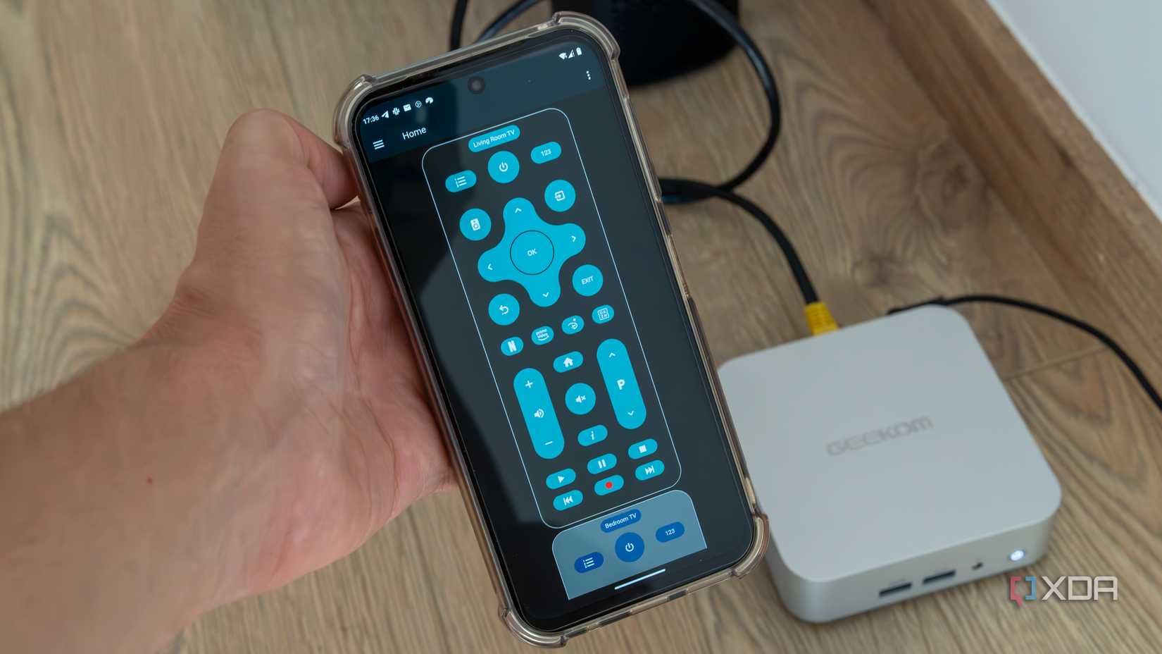 A smartphone running Home Assistant with a remote control for a TV