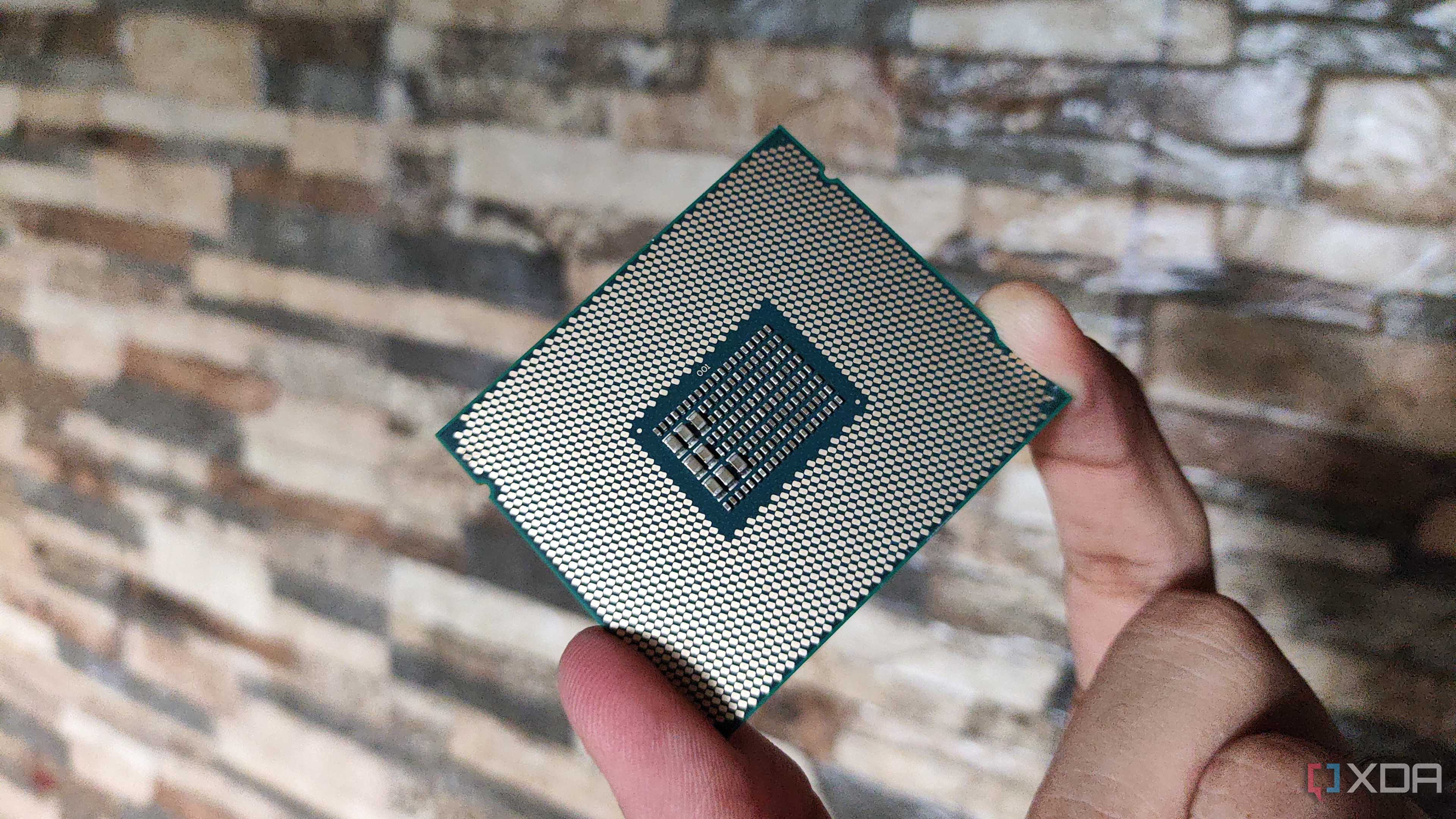 A person holding a server-grade Intel Xeon E5-2650 v4 processor