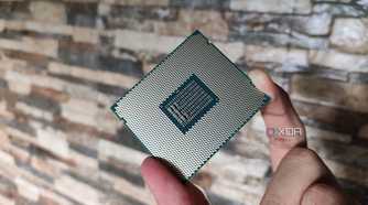 A person holding a server-grade Intel Xeon E5-2650 v4 processor