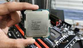 A person holding a server-grade Intel Xeon E5-2650 v4 processor