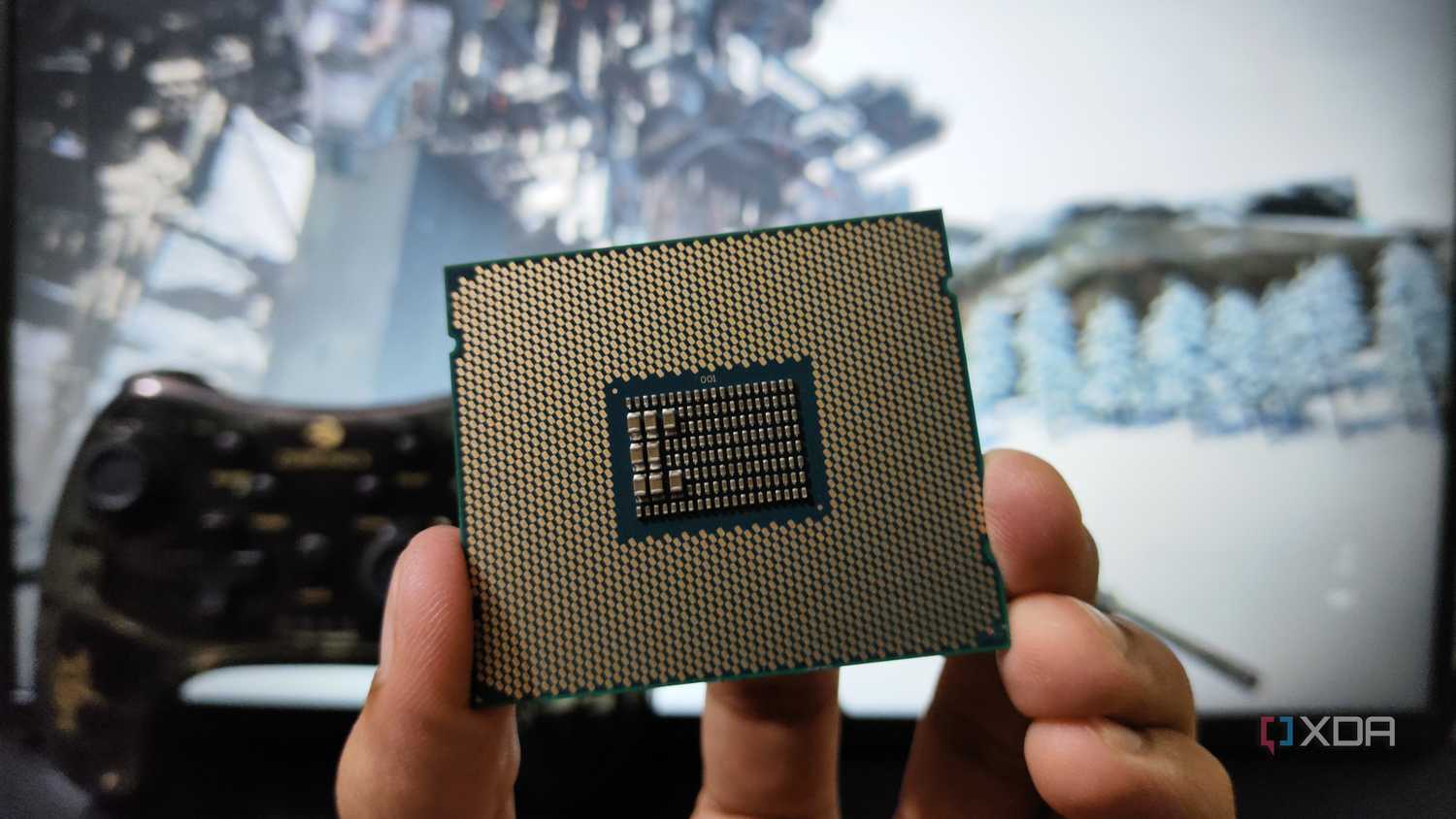 A person holding a server-grade Intel Xeon E5-2650 v4 processor