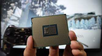 A person holding a server-grade Intel Xeon E5-2650 v4 processor