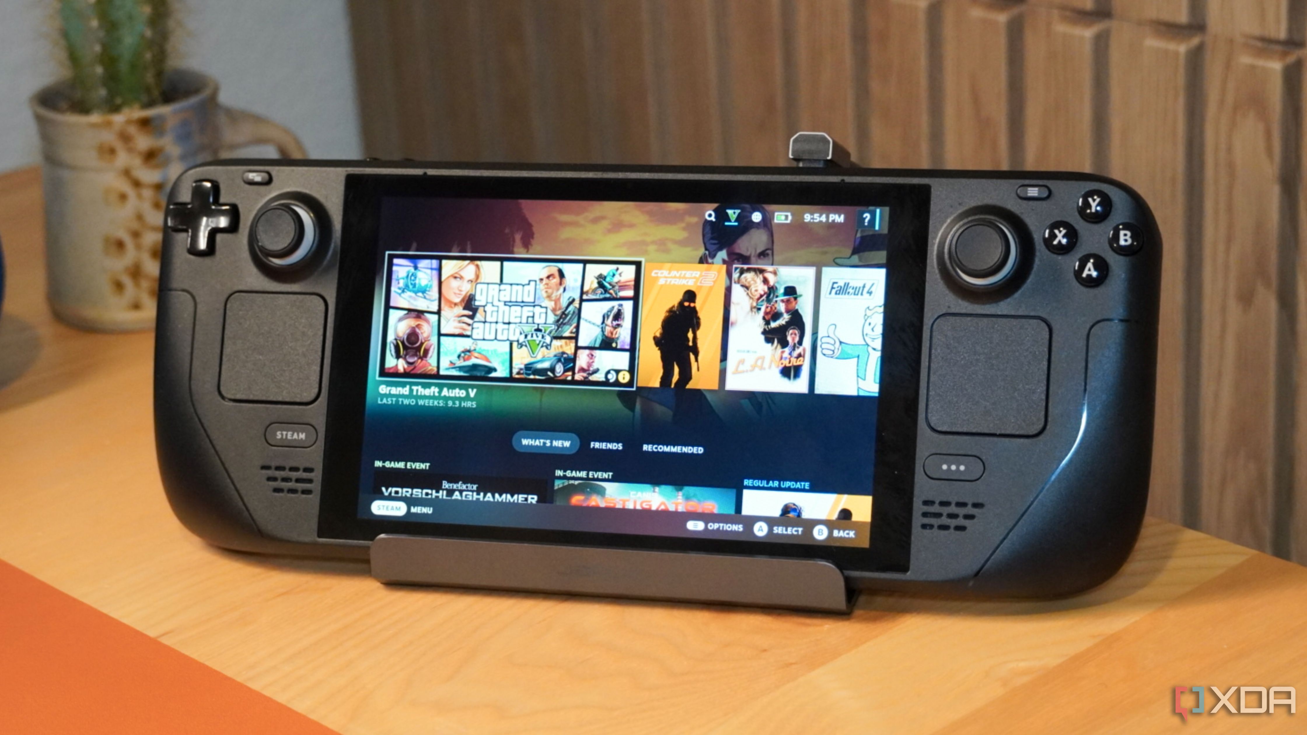 The Jsaux Steam Deck dock holding a Steam Deck with the screen on. 