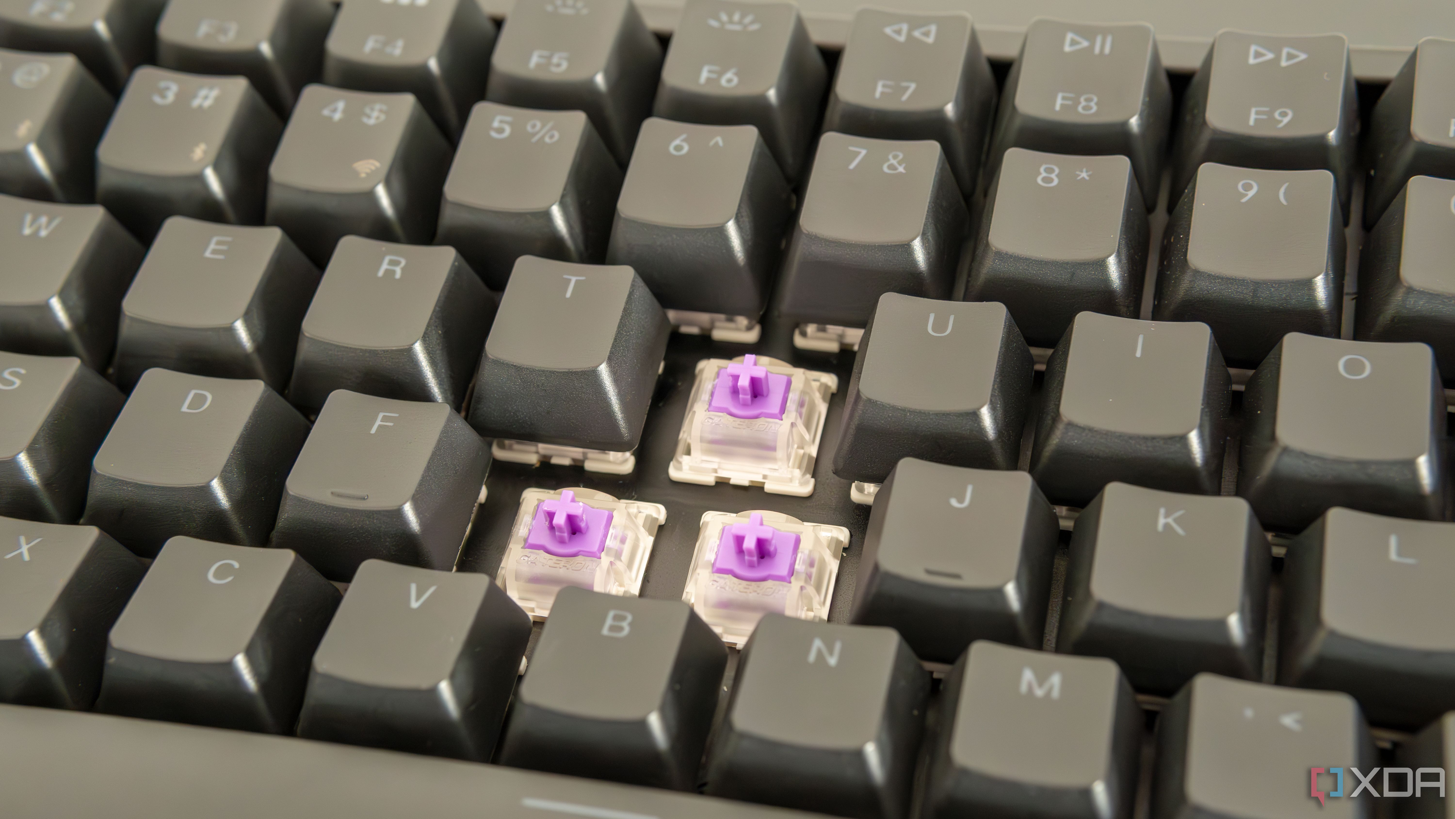 Close-up view of the Keychron K2 HE with three switches exposed and RGB lighting off