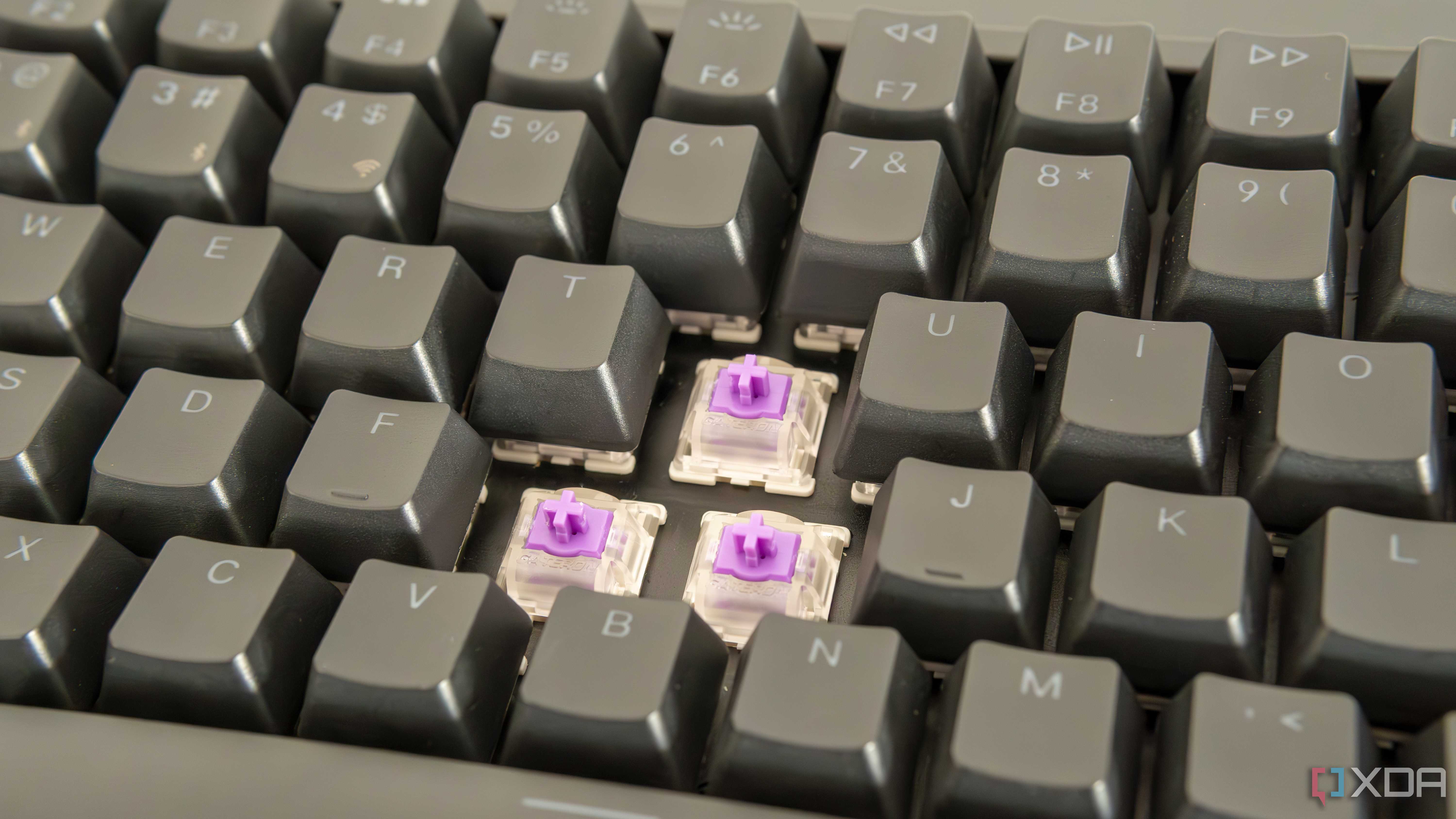 Close-up view of the Keychron K2 HE with three switches exposed and RGB lighting off