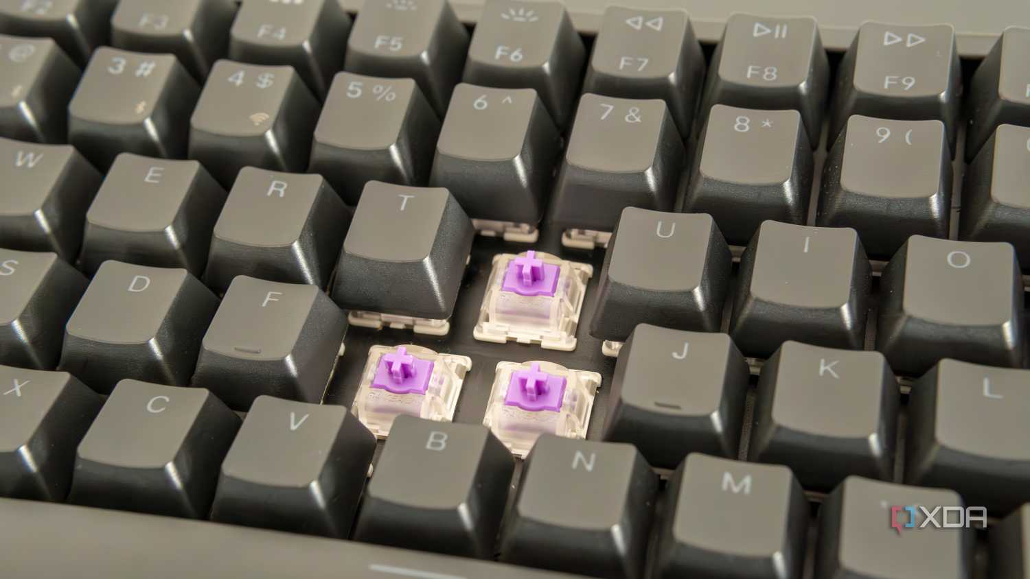 Close-up view of the Keychron K2 HE with three switches exposed and RGB lighting off