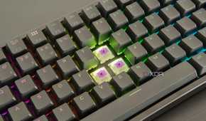 Close-up of the Keychron K2 HE with three keycaps removed, showing the switches underneath