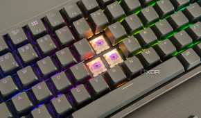 Close-up of the Keychron K2 HE with three keycaps removed, showing the switches underneath