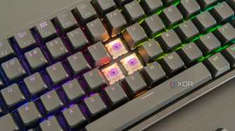 Close-up of the Keychron K2 HE with three keycaps removed, showing the switches underneath