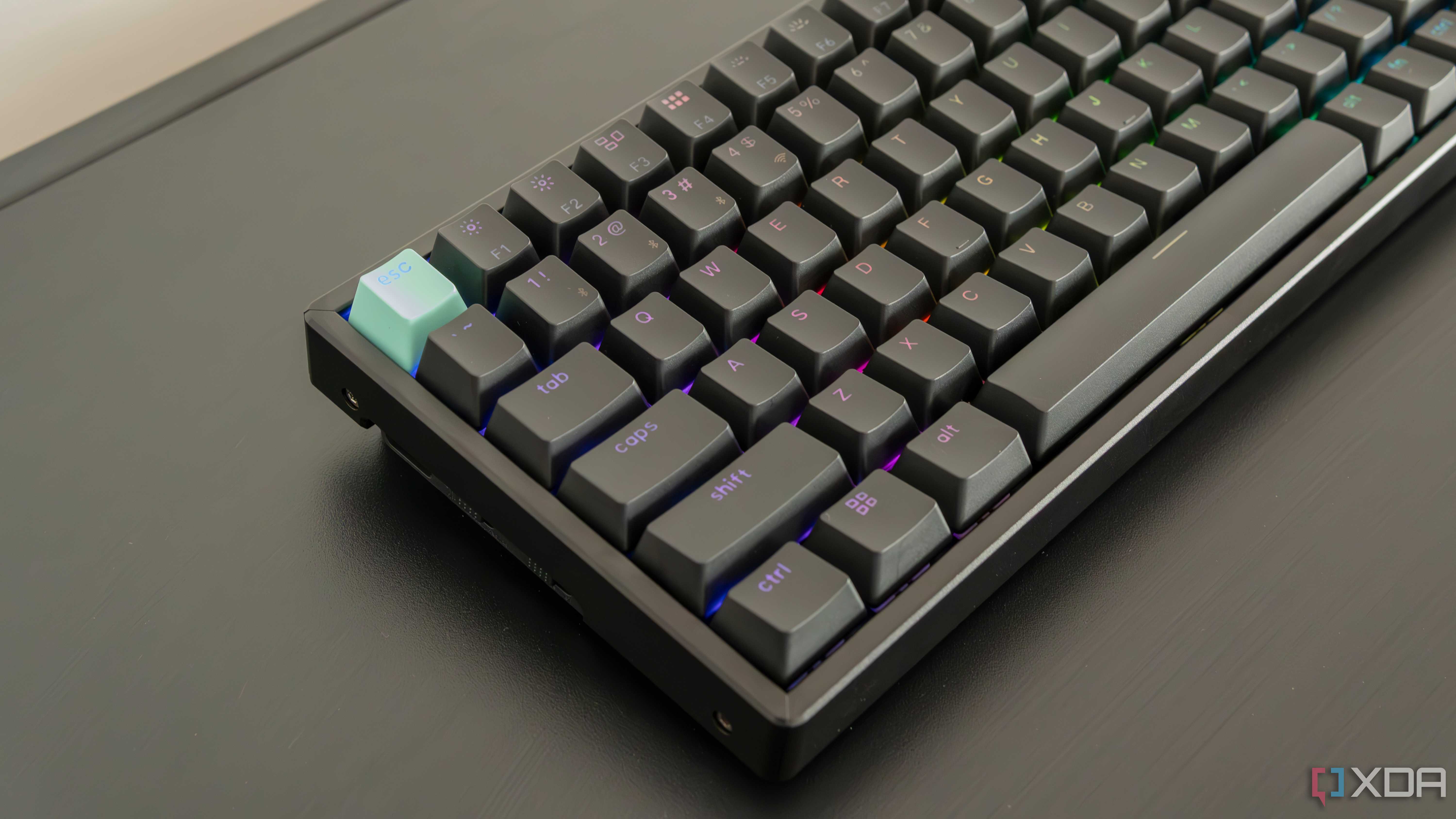 Angled close-up view of the left side of the Keychron K2 HE with RGB lighting enabled