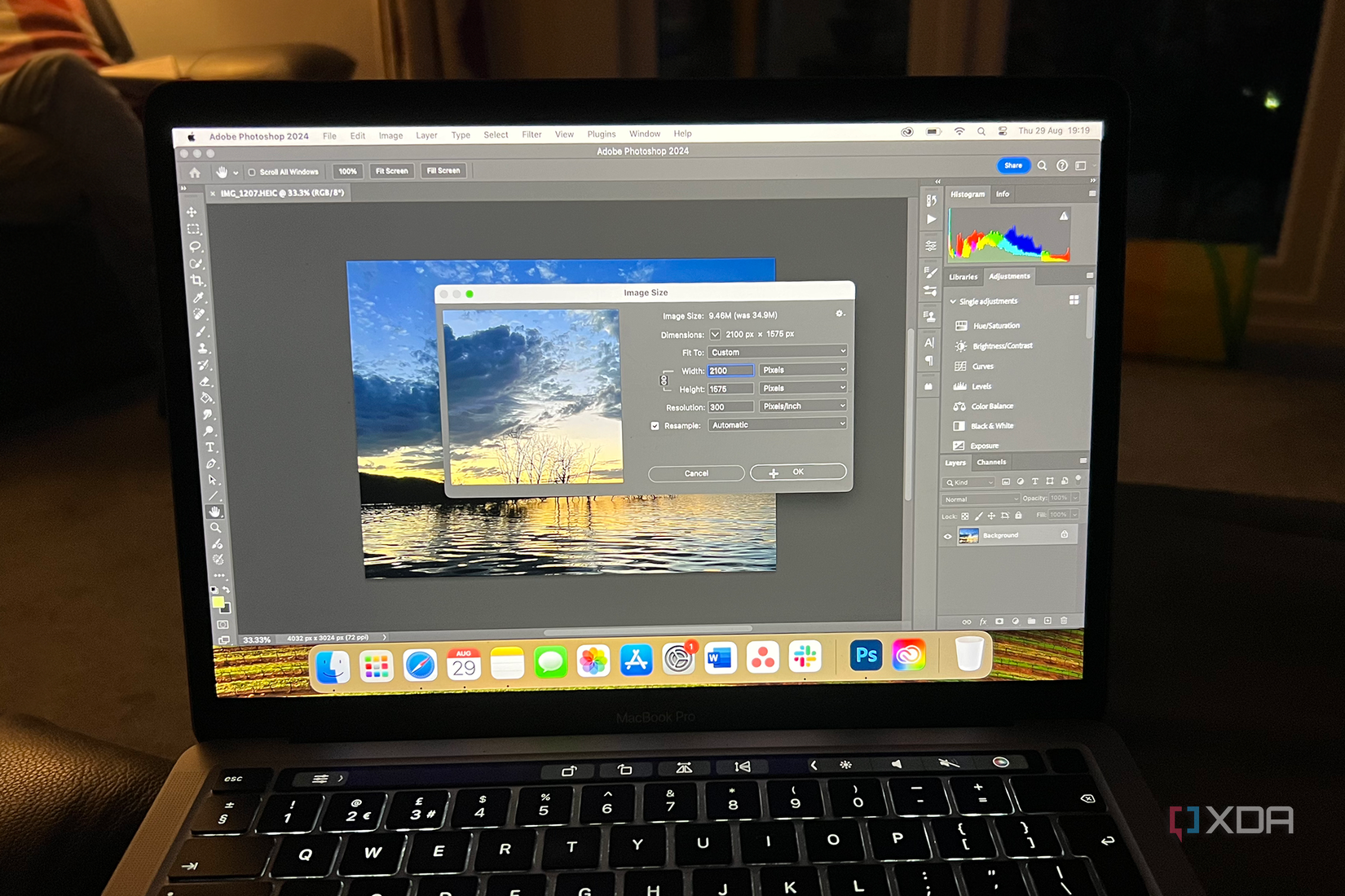 MacBook Pro with Photoshop on screen showing Image Size tool window.