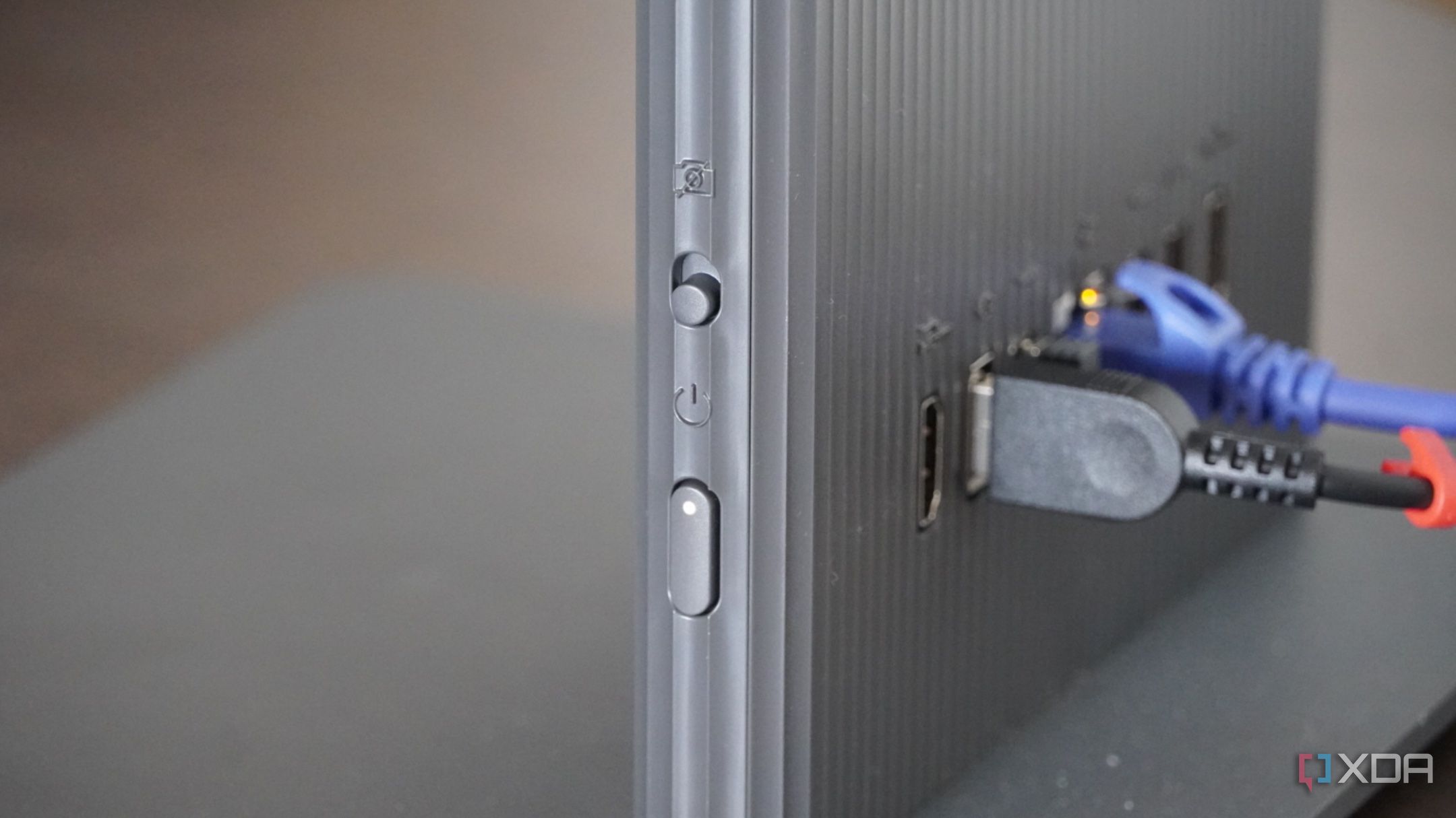 The power switch on the side of the Lenovo AIO. 