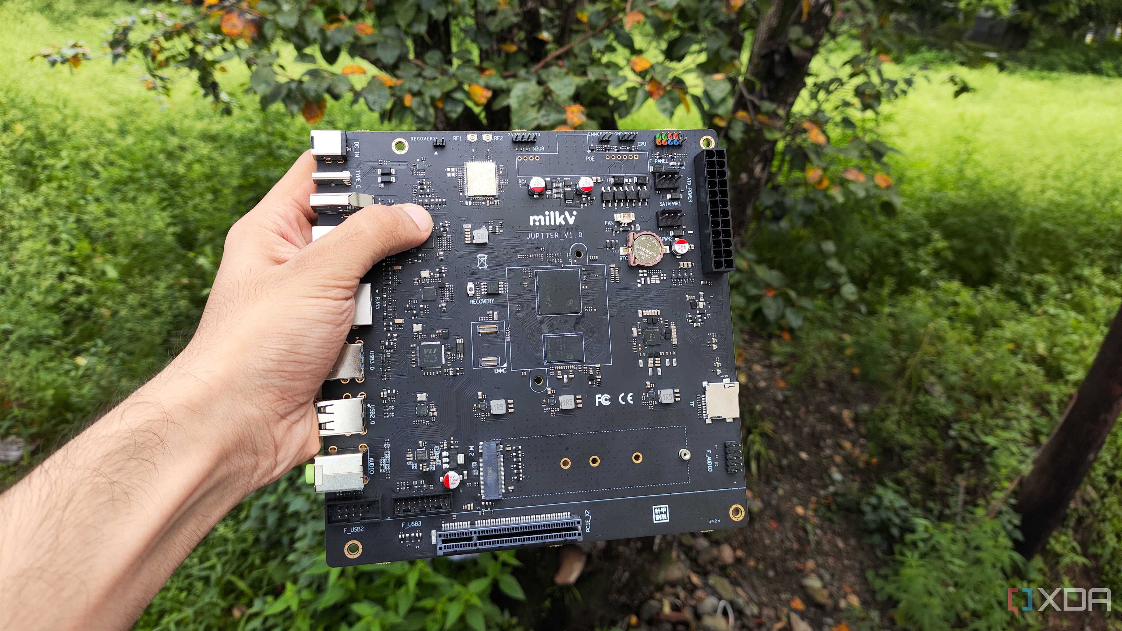 A person holding the K1 version of the Milk-V Jupiter mini-ITX motherboard