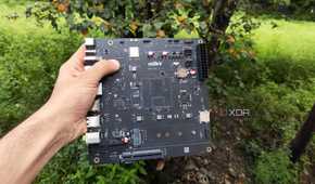 A person holding the K1 version of the Milk-V Jupiter mini-ITX motherboard