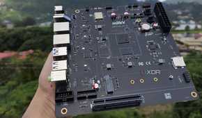 A personal holding the K1 version of the Milk-V Jupiter mini-ITX motherboard