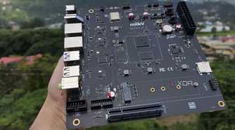 A personal holding the K1 version of the Milk-V Jupiter mini-ITX motherboard
