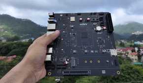 A personal holding the K1 version of the Milk-V Jupiter mini-ITX motherboard