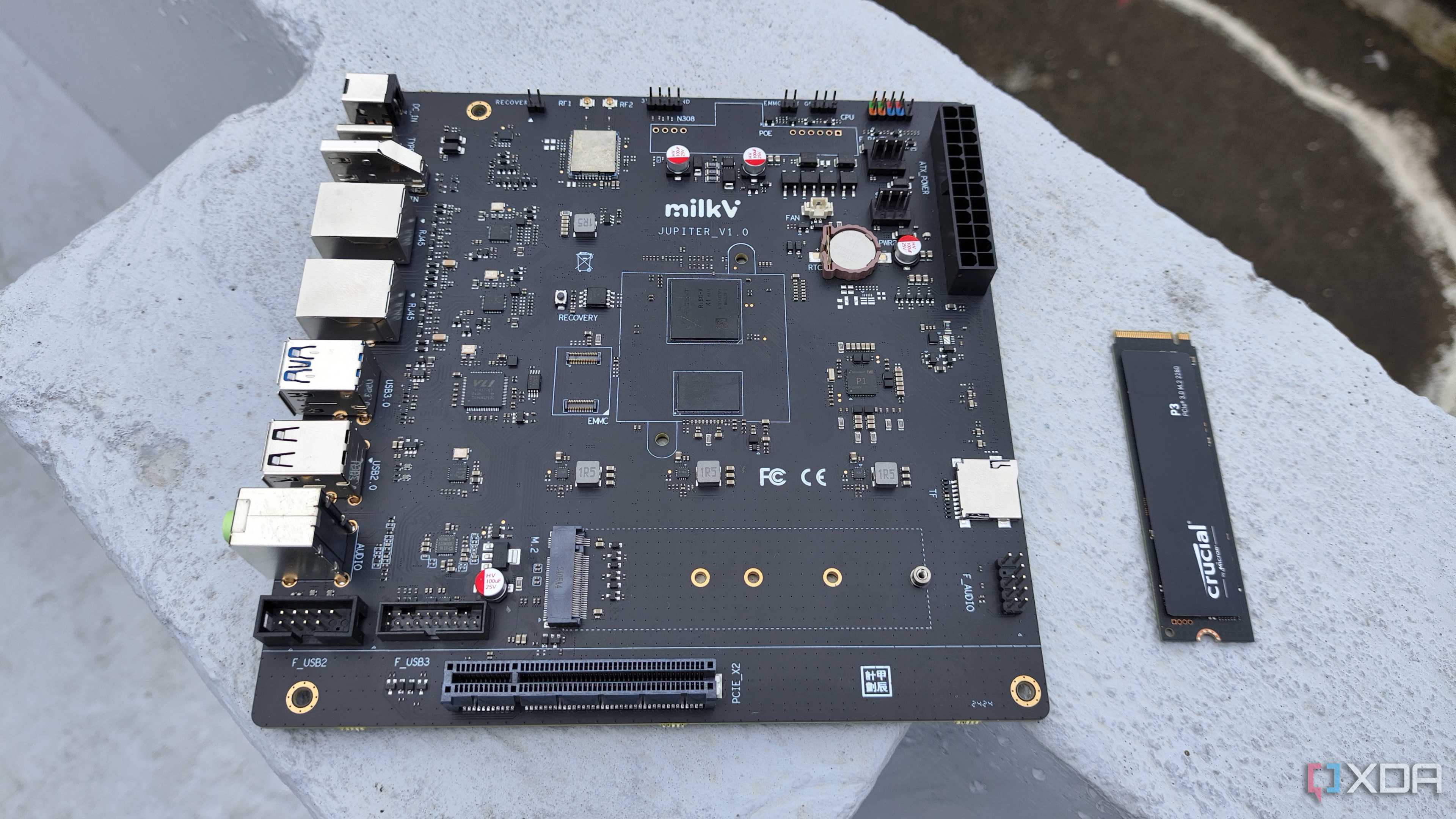 The K1 version of the Milk-V Jupiter mini-ITX motherboard with a PCIe 3.0 SSD lying nearby
