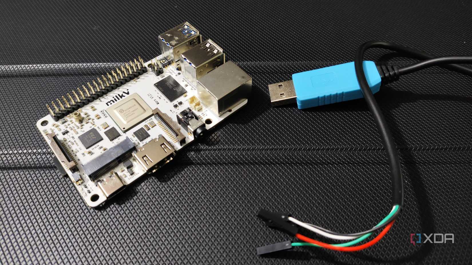 A Milk-V Mars lying next a USB to Serial TTL cable