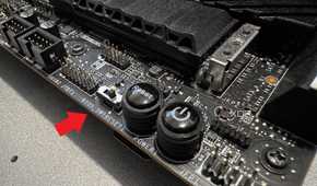 closeup of msi z690 unify-x motherboard with a red arrow pointing at the dual bios switch
