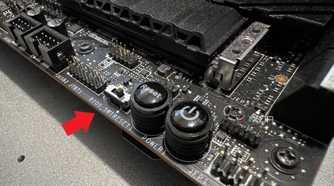 closeup of msi z690 unify-x motherboard with a red arrow pointing at the dual bios switch