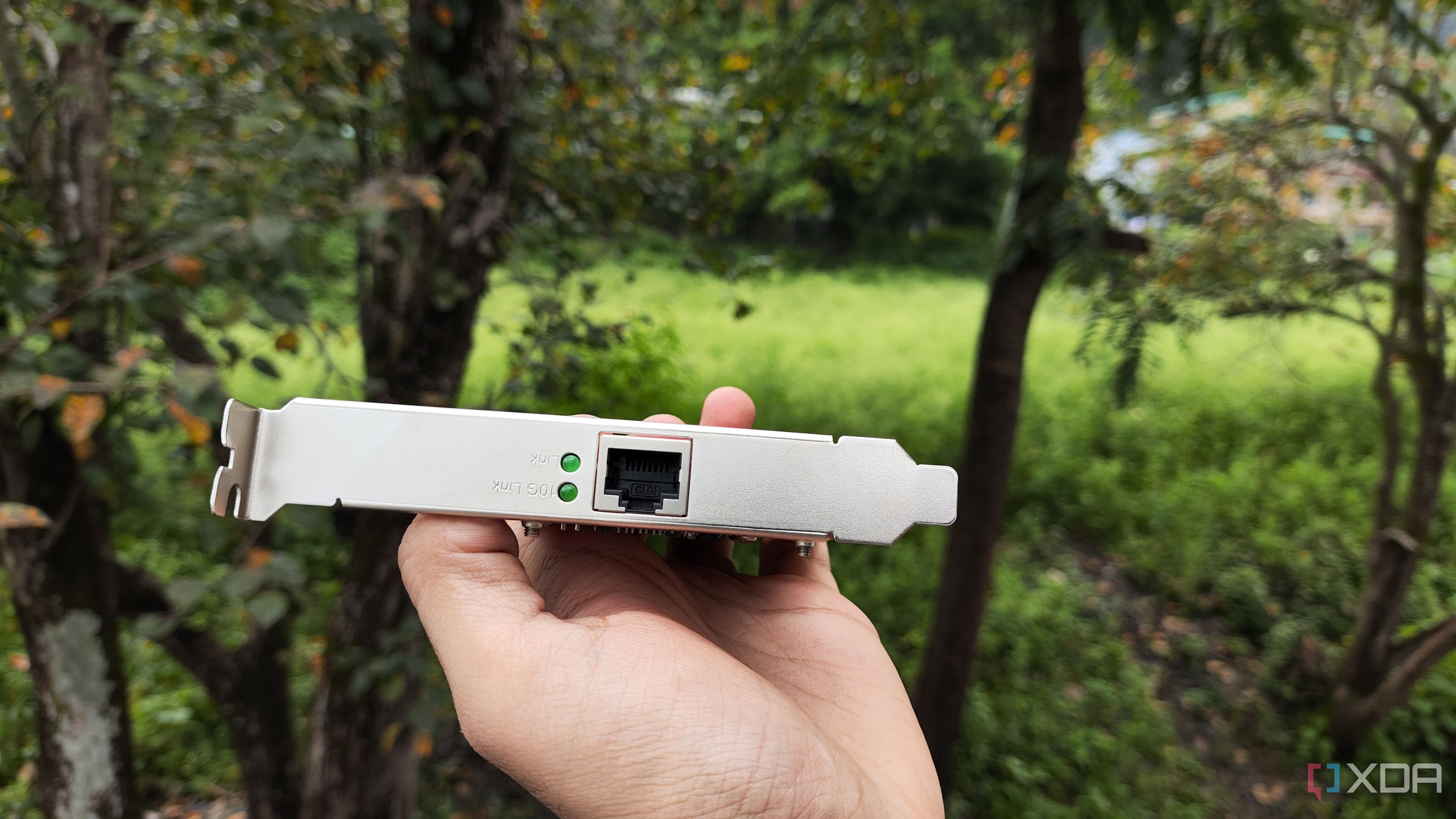 A person holding a TP-Link 10G NIC