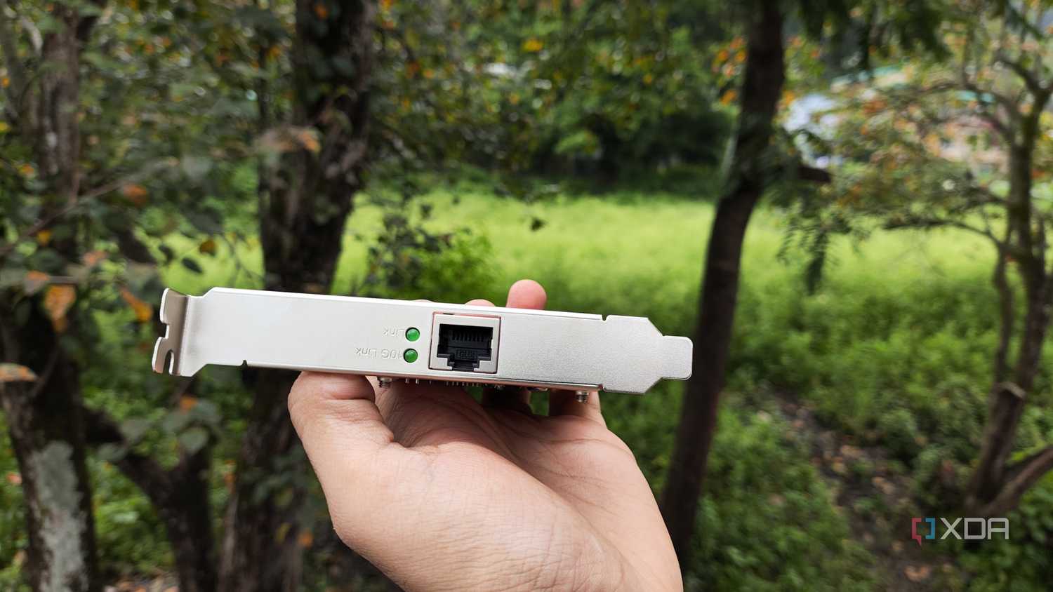 A person holding a TP-Link 10G NIC