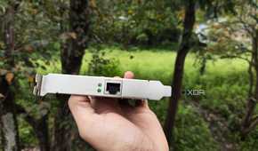 A person holding a TP-Link 10G NIC