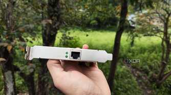 A person holding a TP-Link 10G NIC