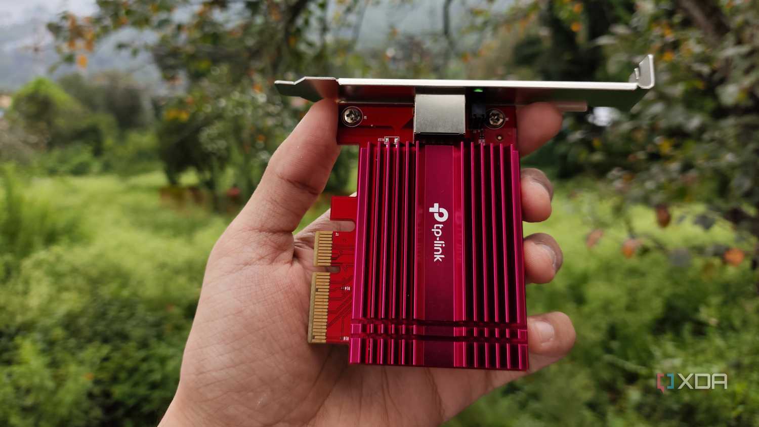 A person holding a TP-Link 10G NIC