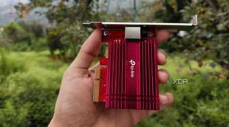 A person holding a TP-Link 10G NIC