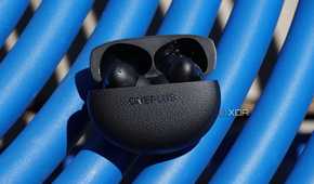 The OnePlus Buds Pro 3 on a blue table.
