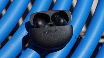 The OnePlus Buds Pro 3 on a blue table.