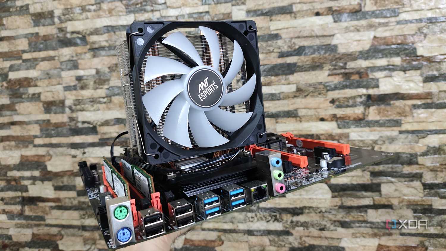 A person holding a dual Xeon X99 motherboard