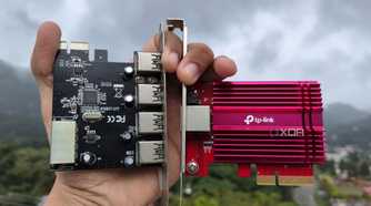 A person holding an NIC and a PCIe-to-USB card